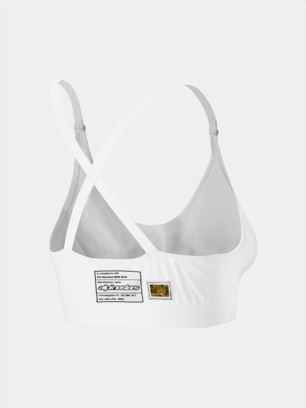 Alpinestars Stella TECH ZX Bra, white flame-resistant racing underwear, rear view showing cross-back strap design, features FIA 8856-2018 homologation label and hologram, lightweight performance base layer for women