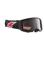 Alpinestars Supertech Corp Goggles Absolute Vision, Motocross Goggles, Black and Red with Mirror Silver Lens, angled profile showing black strap with large red and white star logo, sleek frame design for off-road performance