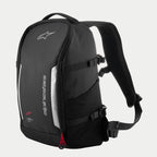 Alpinestars AMP3 Backpack, Black technical motorcycle bag with white logos, silver reflective panels, red zipper pulls, adjustable side compression straps, and padded mesh shoulder straps.
