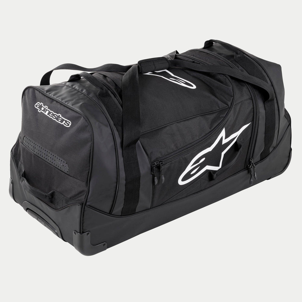 Alpinestars Komodo Travel Bag, stor utrustningsväska för motocross i svart och antracit med vita logotyper, utrustad med hjul och ett teleskophandtag, hållbar konstruktion för transport av racingutrustning