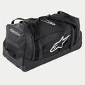Alpinestars Komodo Travel Bag, stor utrustningsväska för motocross i svart och antracit med vita logotyper, utrustad med hjul och ett teleskophandtag, hållbar konstruktion för transport av racingutrustning