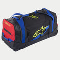 Alpinestars Komodo Travel Bag, utrustningsväska på hjul, svart med blå, röda och fluorescerande gula detaljer, blå vävbandshandtag, röd sidopanel, fluorescerande gula logotyper, hållbar konstruktion med hjul för transport av motocross- och racingutrustning