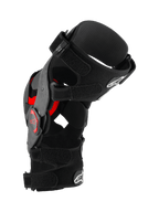 Alpinestars Supertech RK-10 Plasma Knee Brace, Motocross Knee Protector, Black and Red, side profile view showing forged carbon fiber frame, adjustable straps, and red Nucleon PLASMA inserts, protective gear for off-road racing