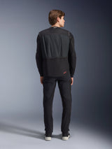 Tech-Air® 3 V2 System, Black, Rear view on male model, autonomous motorcycle airbag vest, worn over a long-sleeved shirt with black pants, featuring a small red Alpinestars logo, slim and lightweight protective gear for road use