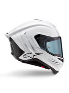Alpinestars Supertech R10 Solid hjälm, vit glansig och svart matt motorcykelracinghjälm, sidoprofil, aerodynamisk design med bakre vingar och sidoventiler, blåtonat visir, svart Alpinestars-stjärnlogotyp på sidan