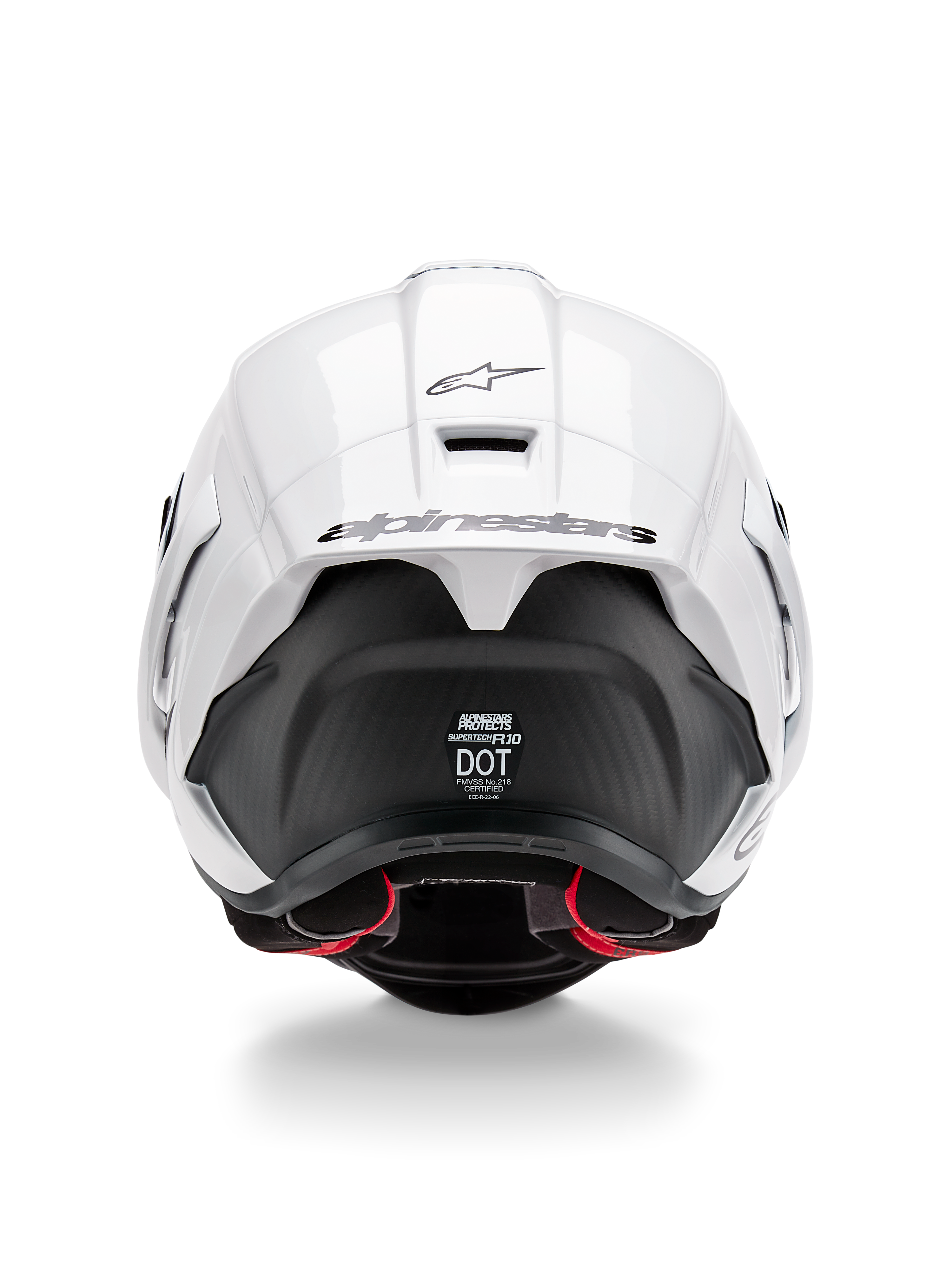 Alpinestars Supertech R10 Solid hjälm, vy bakifrån, blank vit ovansida med matt svart nedre del, aerodynamisk spoiler med svart Alpinestars-logotyp, synlig kolfiberstruktur och säkerhetscertifieringsdekaler