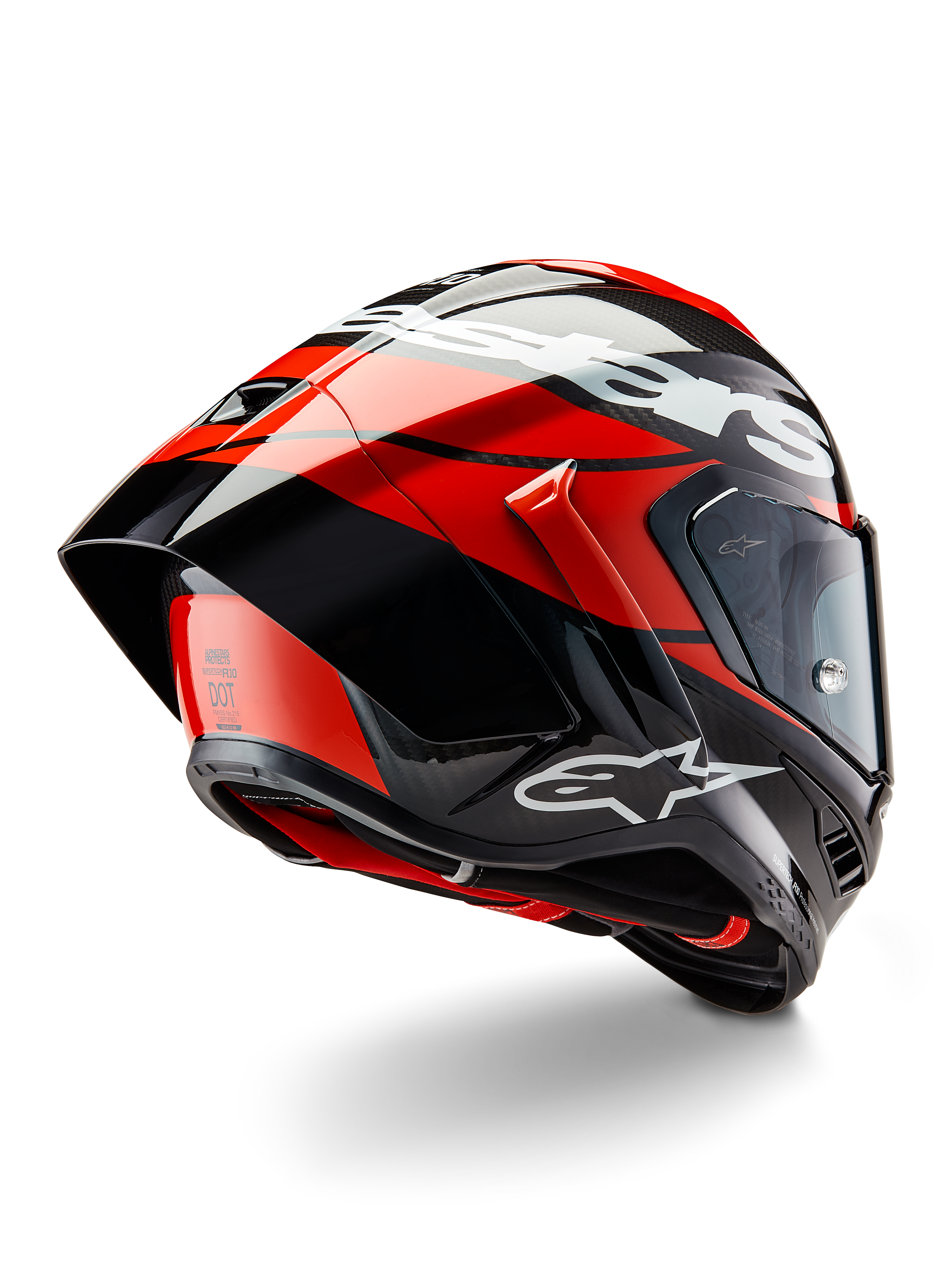 Alpinestars Supertech R10 Element hjälm, svart kolfiber, ljusröd och vit blank, trekvartsvy bakifrån som visar stor aerodynamisk spoiler och kolfiberskal, med tydliga Alpinestars-logotyper och DOT-certifiering