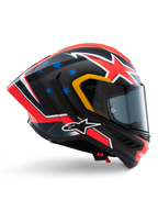 Alpinestars Supertech R10 Miller Limited Edition Helmet, full-face racing helmet, matte carbon with red white and blue graphics, blue star accents and yellow visor trim, aerodynamic profile with dark smoke shield, high-performance motorcycle safety gear