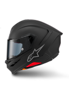 Alpinestars S-R7 Solid hjälm, integralhjälm för motorcykel, mattsvart, sidoprofil, med silverfärgad Astars-logotyp på sidan, aerodynamisk design med integrerad spoiler och hakventiler, samt röda och orangea detaljer vid basen.