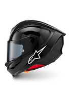 Alpinestars S-R7 Solid-hjälm, integralhjälm för motorcykel, blanksvart (Black Glossy), profilvy från vänster sida med vit Alpinestars-logotyp, aerodynamiskt skal med integrerad spoiler, tonat visir och röda detaljer för nödlossningssystemet.