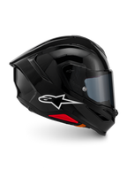 Alpinestars S-R7 Solid hjälm, integralhjälm för motorcykel, blanksvart, profilvy med vit A-star-logotyp, strömlinjeformat aerodynamiskt skal med integrerad spoiler och röda detaljer vid basen, designad för racing och sportprestanda.
