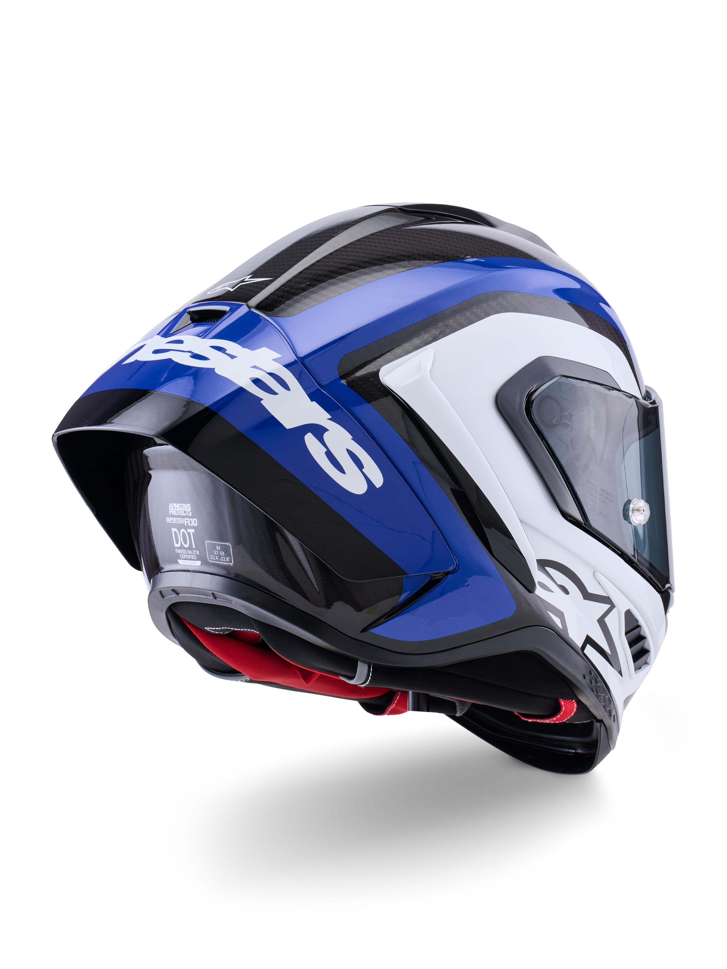Alpinestars Supertech R10 Arius-hjälm, integralhjälm för racing, svart, vit och blå glansig yta, trekvartsvy bakifrån som visar den aerodynamiska spoilern, synlig kolfibertextur och framträdande vit Alpinestars-branding