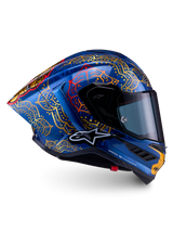 Supertech R10 Martinator Thai Helmet in glossy blue carbon with intricate gold mandala graphics and a racing profile.