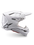 Alpinestars Supertech M10 Solid-hjälm, ECE 22.06-certifierad vit glansig motocrosshjälm med svart logotyp, skärm och ventilerad heltäckande design i sidovy