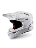 Alpinestars Supertech M10 Solid hjälm, ECE 22.06-godkänd vit glansig motocrosshjälm med svart och rött innerfoder, skärm och flera ventilationsöppningar, visad i trekvartsvy