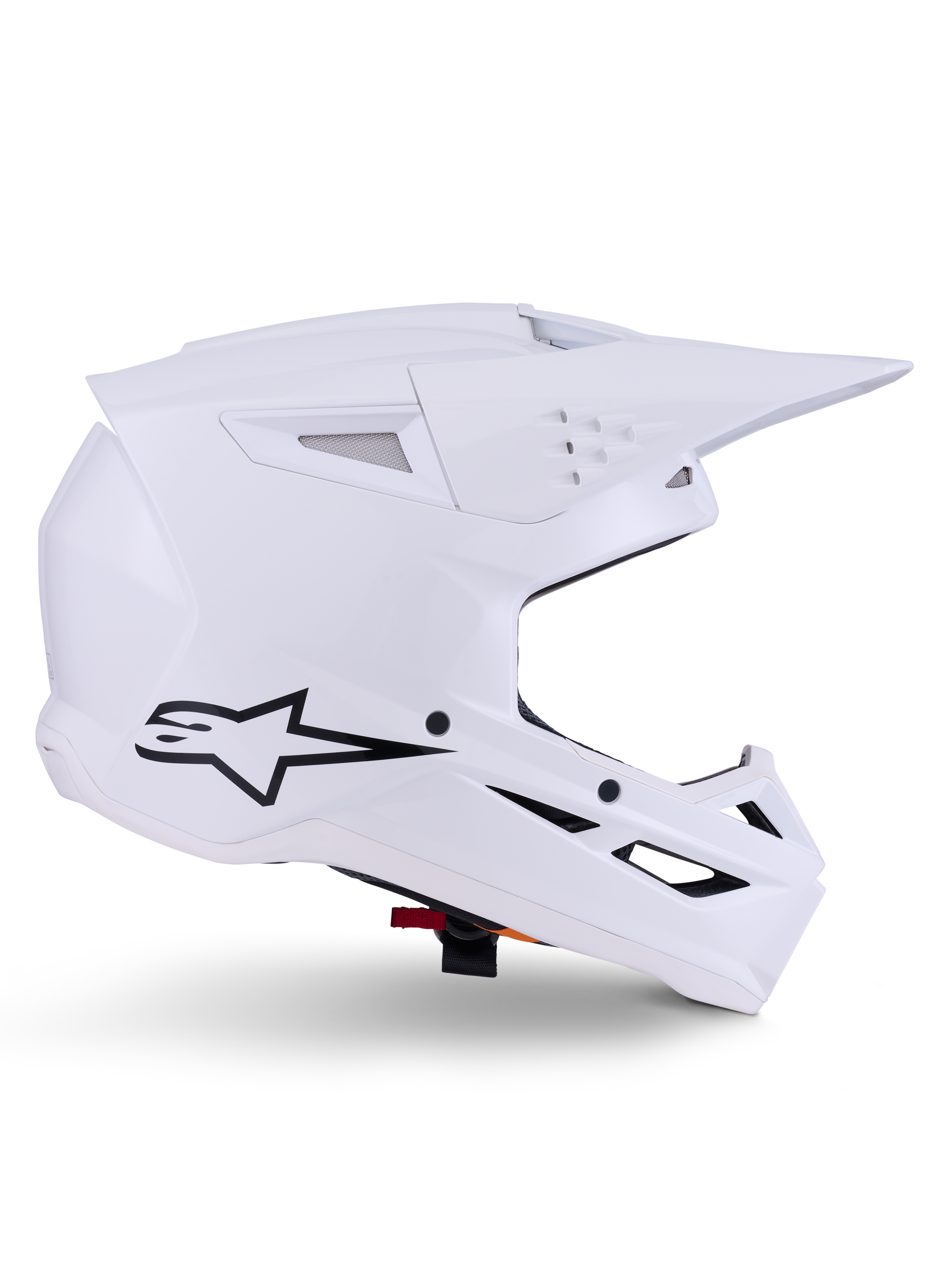 Alpinestars S-M3 Solid hjälm, motocrosshjälm, blankvit, profilvy med svart stjärnlogotyp, vinklat aerodynamiskt skal, flera ventilationsöppningar, integrerat visir och hakskydd, skydd för terrängkörning