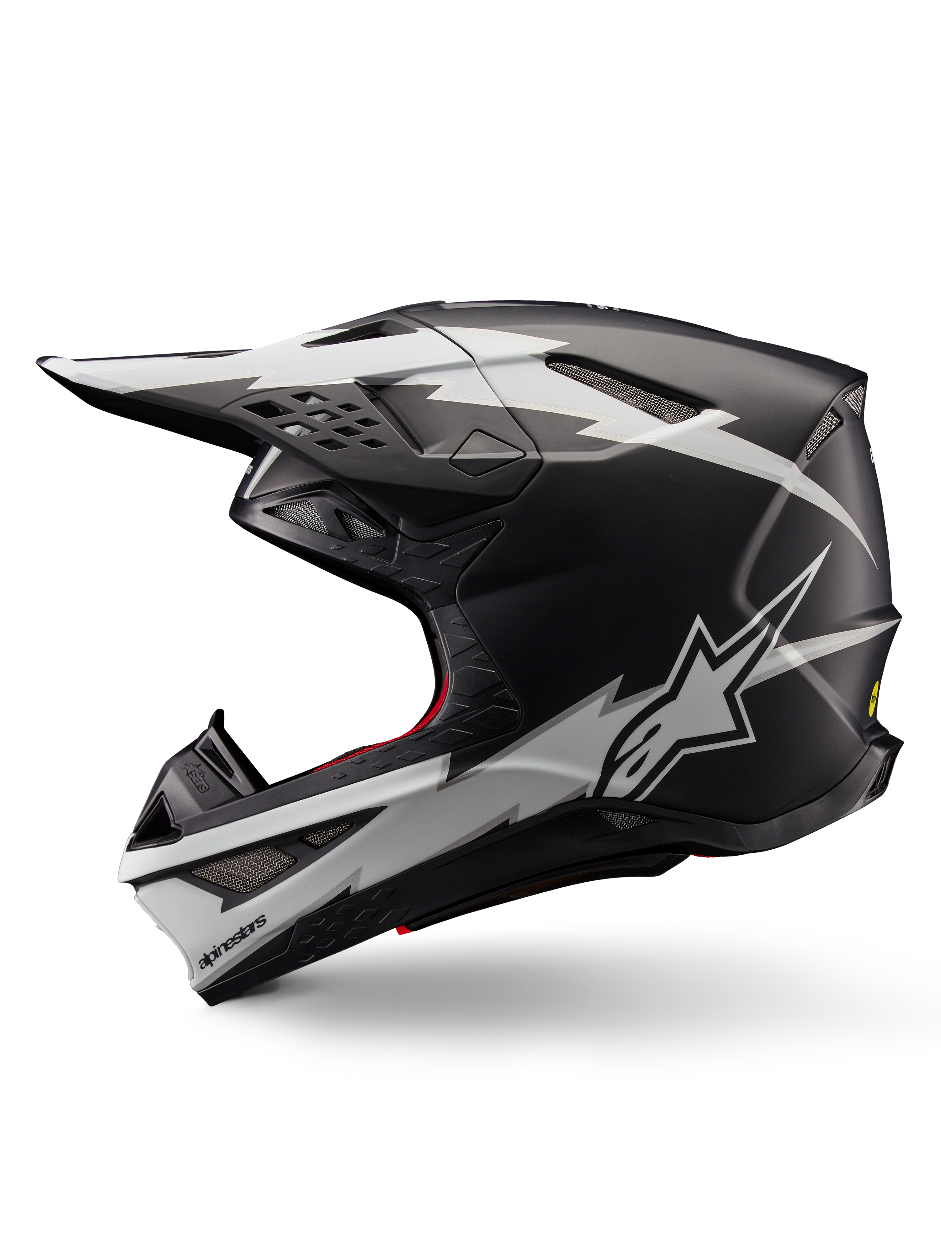 Alpinestars Supertech M10 Ampress Helmet, Motocross Helmet, Matte Black and White, profile view featuring bold white lightning-style graphics, aerodynamic shell with visible ventilation ports and visor, advanced off-road protection