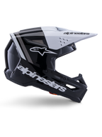 Alpinestars S-M3 Radium Helmet, Motocross Off-Road Helmet, Black White and Gray Glossy, featuring an angular aerodynamic design with ventilation ports, side profile view, glossy finish with gray stripes, and a white visor with Alpinestars branding