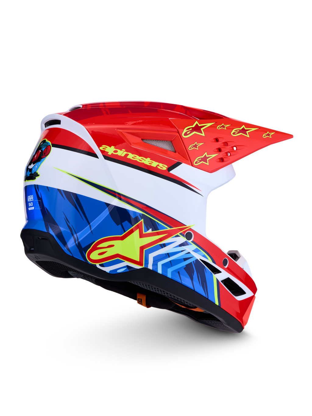 Alpinestars SM3 Falcon hjälm ECE06, röd och blå motocrosshjälm med gula stjärnor och grafik, vit bas, aerodynamisk off-road-design, ECE 2206-certifierad.