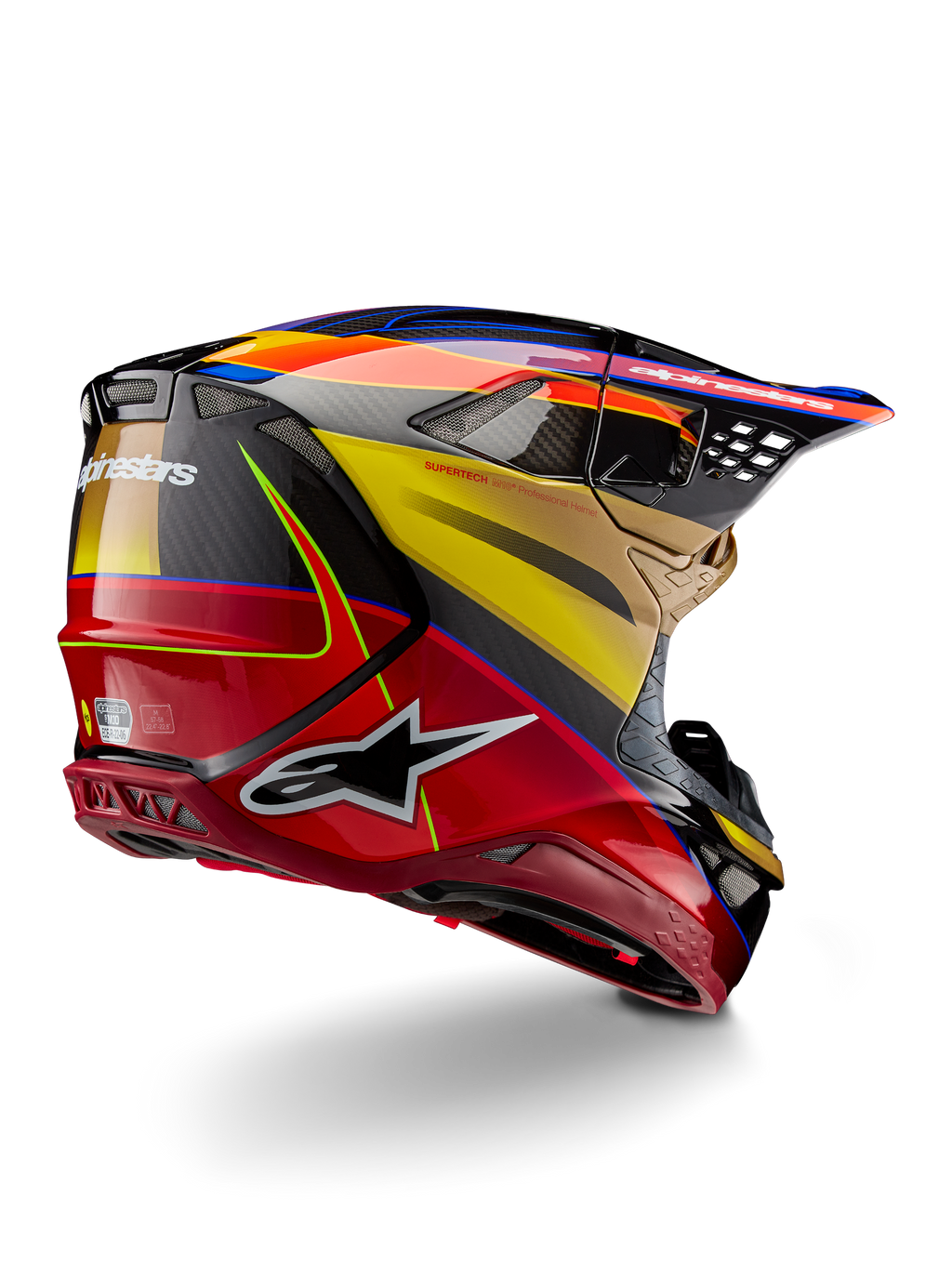 Alpinestars Supertech M10 Era hjälm, motocrosshjälm, Gold Yellow Rio Red Glossy, vinklad vy bakifrån som visar kolfiberskal med röd och gul grafik, blå accenter, aerodynamisk profil med flera ventilationsöppningar och tydlig Astar-logotyp.