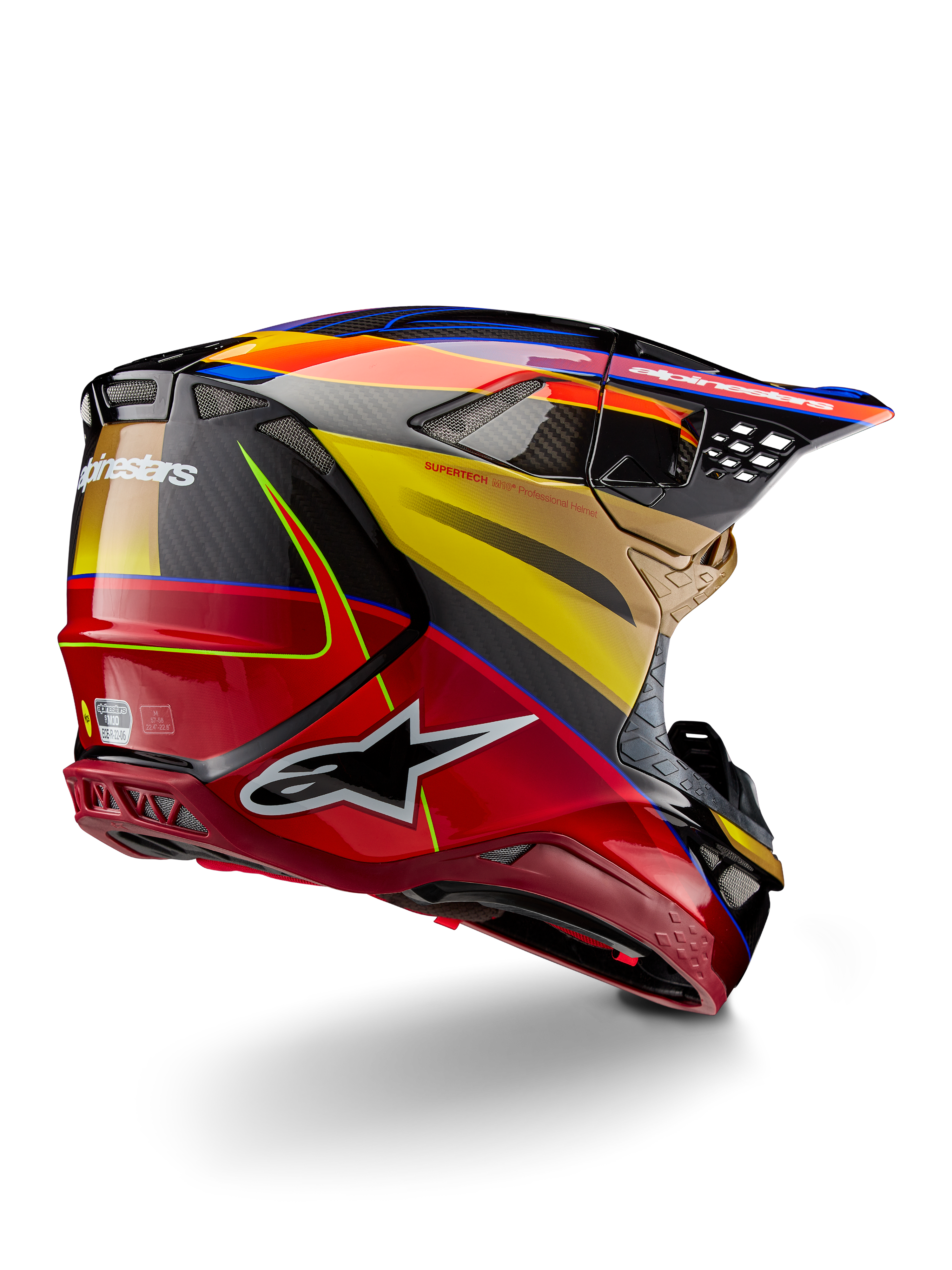Alpinestars Supertech M10 Era hjälm, motocrosshjälm, Gold Yellow Rio Red Glossy, vinklad vy bakifrån som visar kolfiberskal med röd och gul grafik, blå accenter, aerodynamisk profil med flera ventilationsöppningar och tydlig Astar-logotyp.