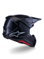 Alpinestars S-M7 Solid-hjälm, motocrosshjälm, blanksvart med ett strömlinjeformat aerodynamiskt skal, silverfärgad Astars-logotyp, röd innerkant och integrerade ventilationsportar, designad för skydd vid terrängkörning