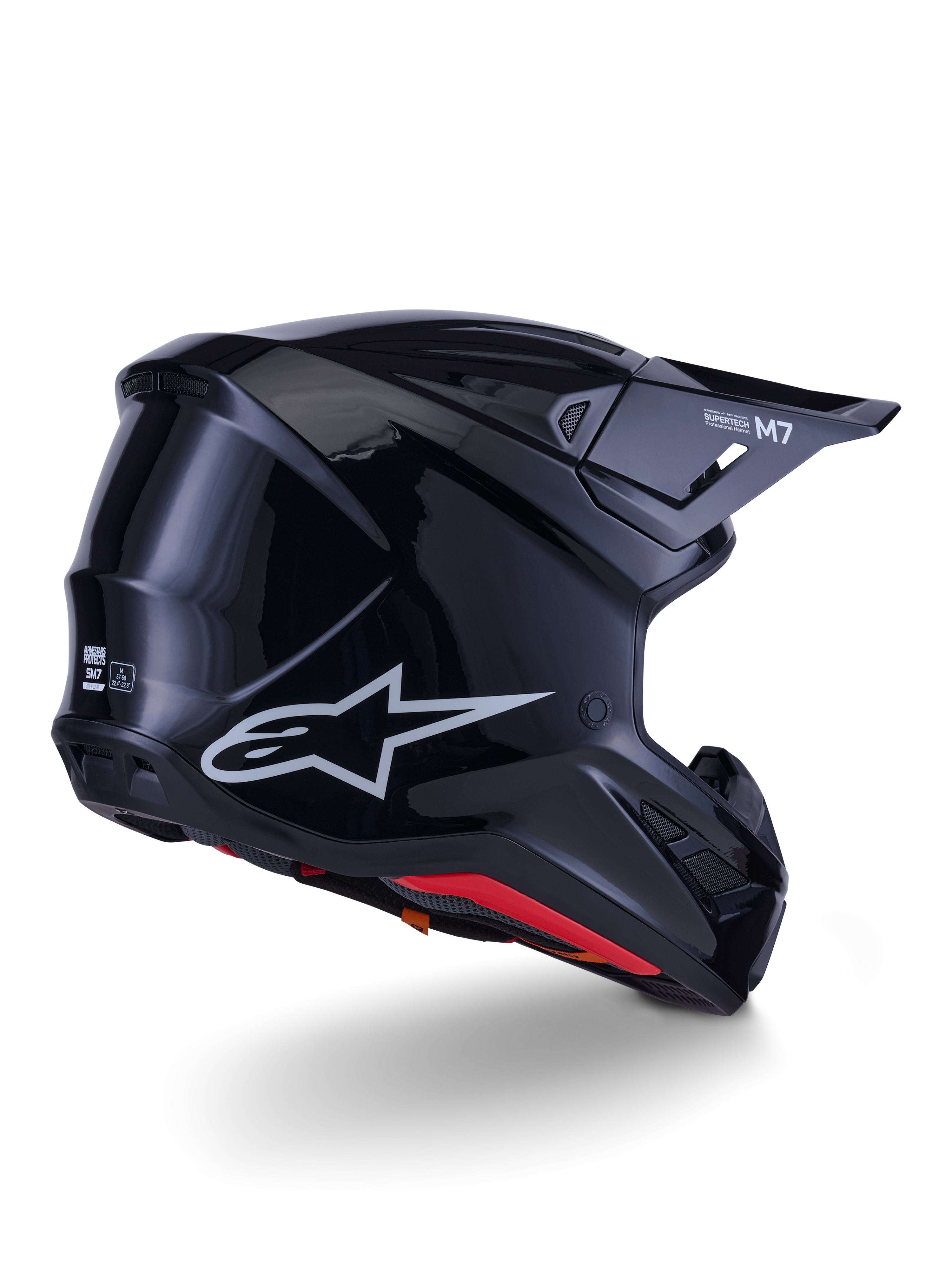 Alpinestars S-M7 Solid-hjälm, motocrosshjälm, blanksvart med ett strömlinjeformat aerodynamiskt skal, silverfärgad Astars-logotyp, röd innerkant och integrerade ventilationsportar, designad för skydd vid terrängkörning