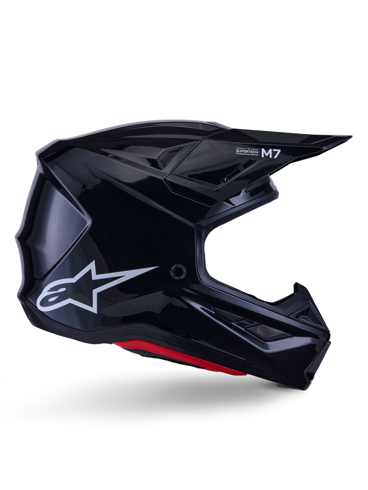 Alpinestars S-M7 Solid-hjälm, motocrosshjälm, blanksvart med vit stjärnlogotyp och röda detaljer, sidoprofil med aerodynamisk design, vinklade nätventiler och Supertech M7-logotyp på visiret.