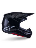 Alpinestars S-M7 Solid-hjälm, motocrosshjälm, blanksvart med vit stjärnlogotyp och röda detaljer, sidoprofil med aerodynamisk design, vinklade nätventiler och Supertech M7-logotyp på visiret.