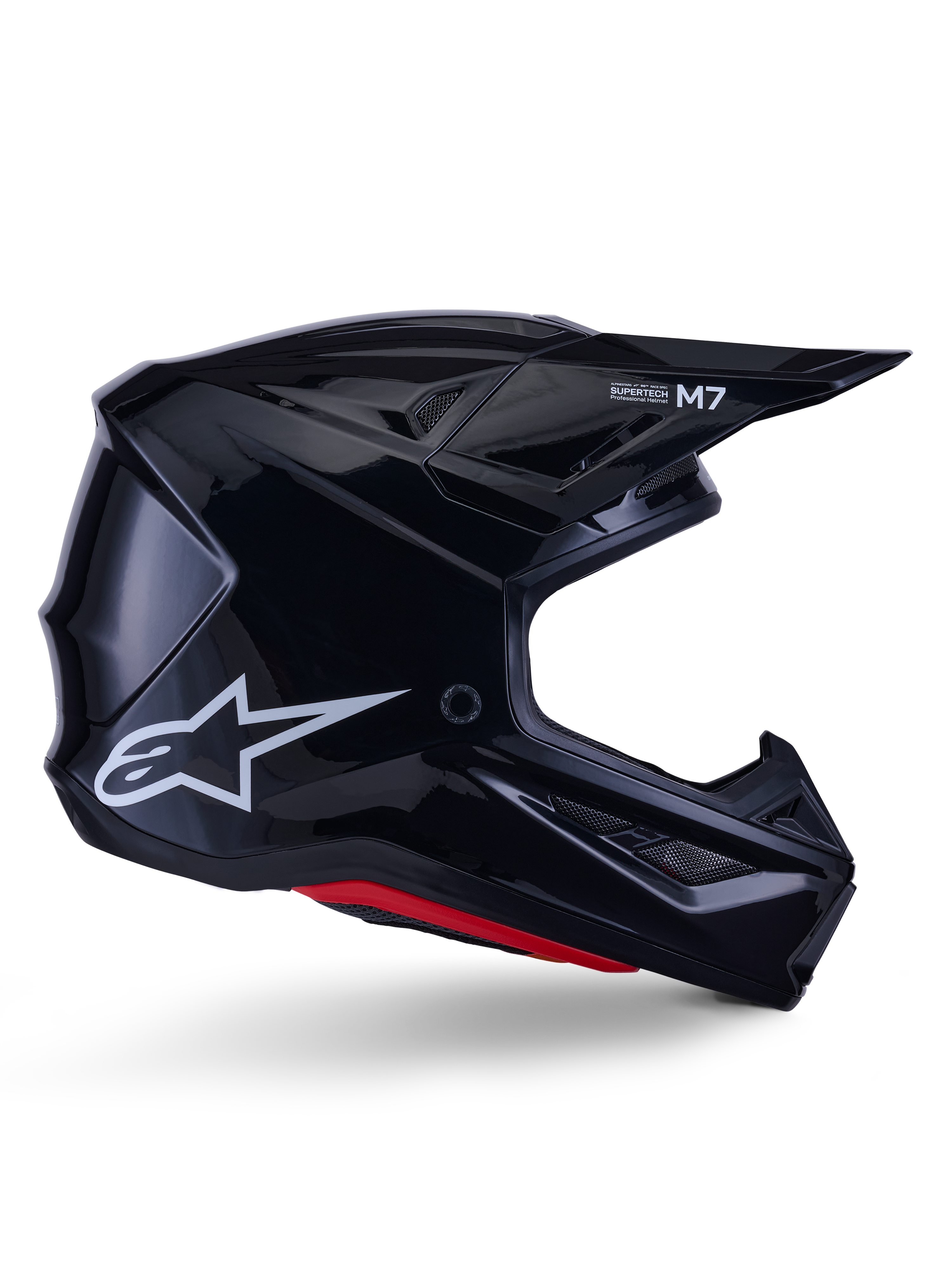 Alpinestars S-M7 Solid-hjälm, motocrosshjälm, blanksvart med vit stjärnlogotyp och röda detaljer, sidoprofil med aerodynamisk design, vinklade nätventiler och Supertech M7-logotyp på visiret.