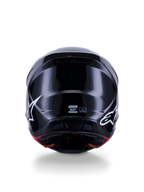 Alpinestars S-M7 Solid-hjälm ECE 22.06, motocrosshjälm, blanksvart, baksida med vita stjärnlogotyper, aerodynamiskt kompositskal med högblank yta, säkerhetscertifiering och storleksetiketter i mitten