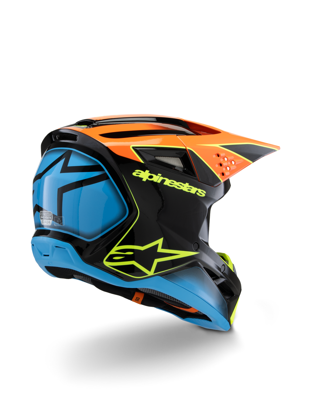 Alpinestars S-M3 Youth Fray-hjälm, motocrosshjälm, svart, orange och blå med neongula detaljer, vy snett bakifrån som visar tydlig Alpinestars-logotyp och stjärnsymbol, strömlinjeformad aerodynamisk design för offroad-racing för ungdomar