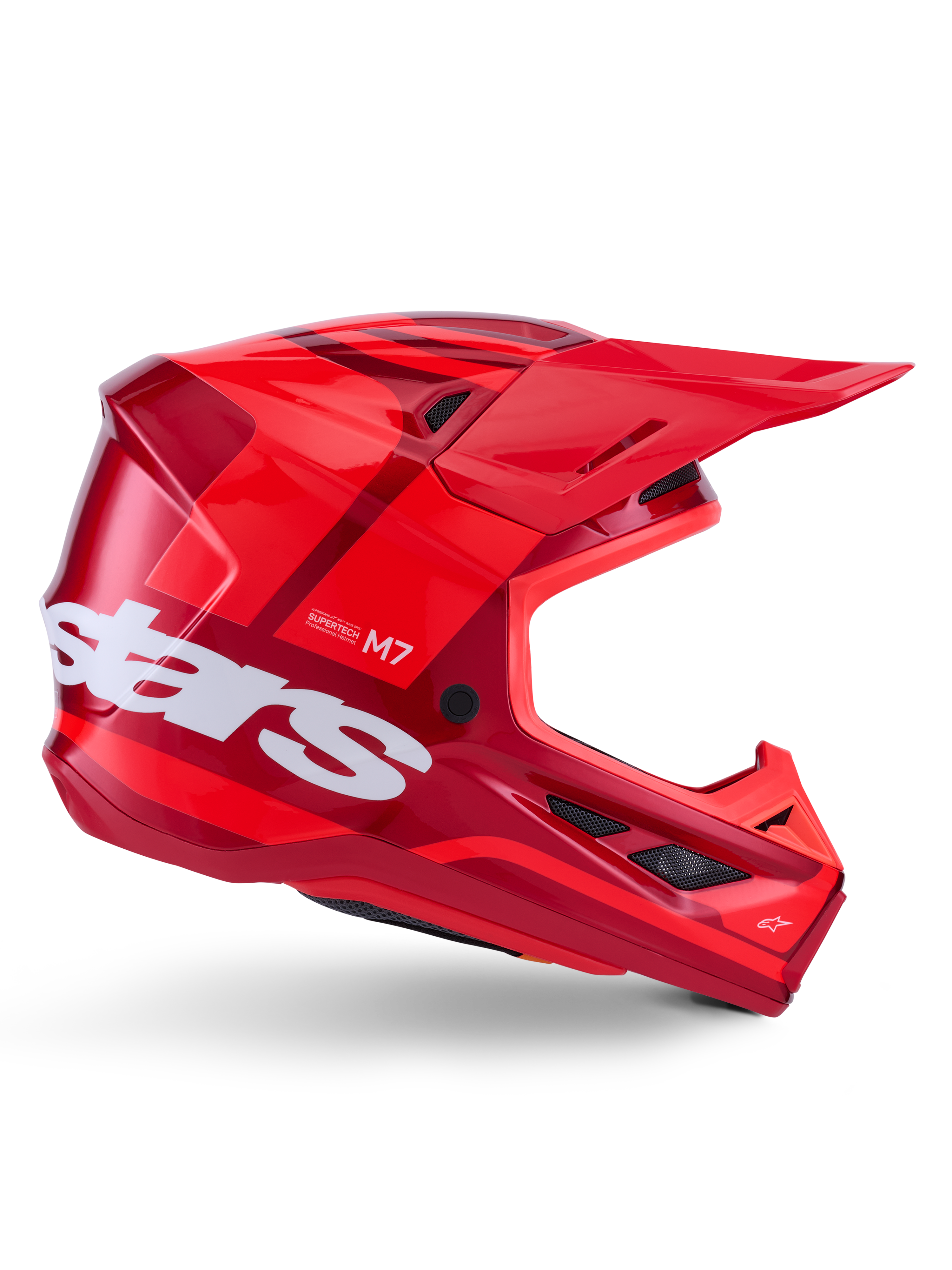 Alpinestars S-M7 Core-hjälm, motocrosshjälm, blank röd med mörkröda detaljer och vit logotyp, sidovy med en stor vit stars-logotyp, aerodynamiskt skal med ventilationsöppningar i nät och ett framträdande visir