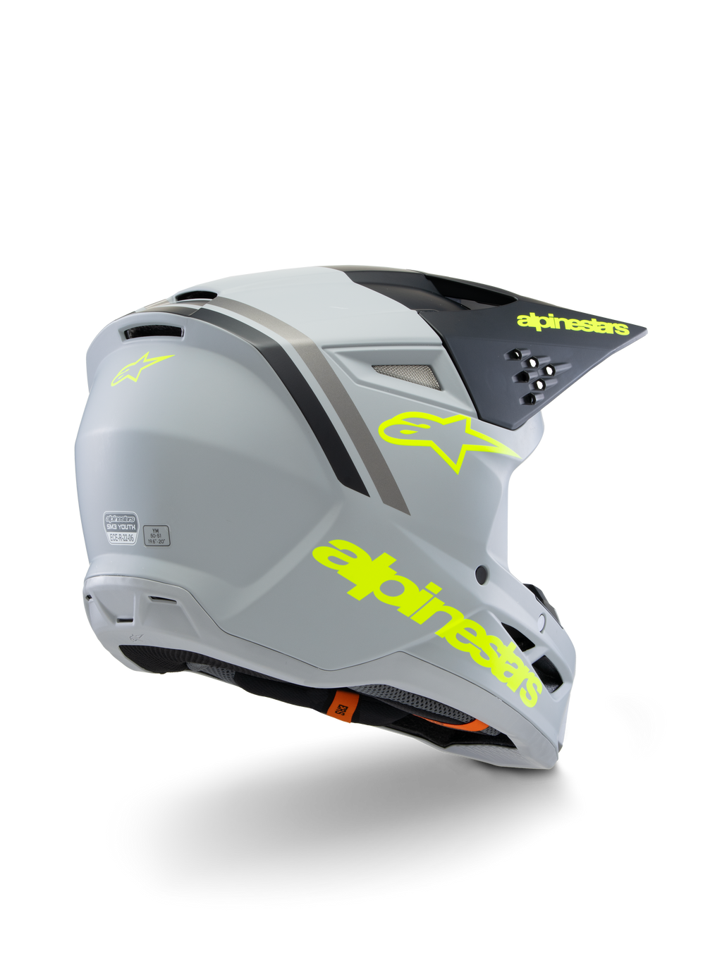 Alpinestars S-M3 Youth Radium Helmet ECE 22.06, motocrosshjälm, grå, svart och fluorescerande gul matt, vy trekvarts bakifrån som visar tydlig gul logotyp och stjärnsymbol, strömlinjeformat aerodynamiskt skal med ventilation för terrängkörning