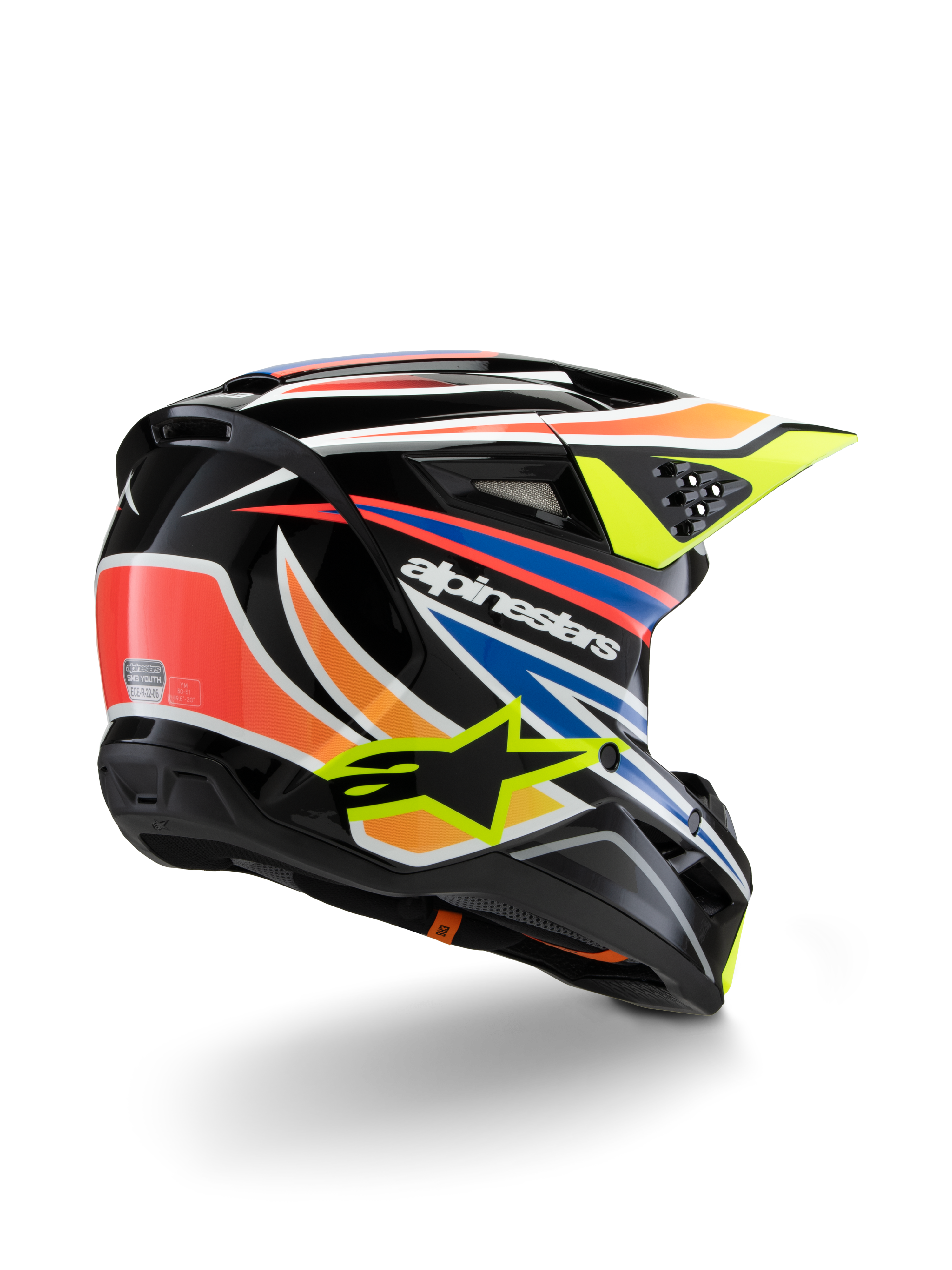 Alpinestars S-M3 Youth Wurx-hjälm, motocrosshjälm för ungdomar, svart med livfulla orangea, röda, blå och neon gula detaljer, vy snett bakifrån som visar det aerodynamiska skalet och ventilationsöppningar, glansig finish med tydlig Alpinestars-branding.