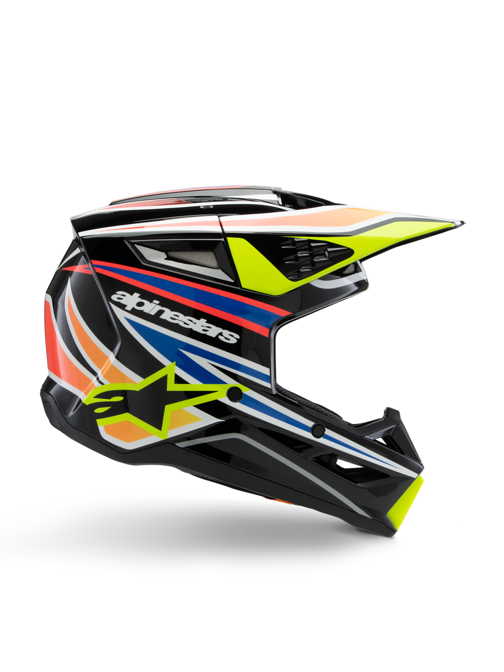 Alpinestars S-M3 Youth Wurx hjälm, ungdomsmotocrosshjälm, svart med grafiska ränder i gult, blått, rött och orange, sidoprofil med aerodynamisk skärm och blank finish, vit Alpinestars-logotyp och gul stjärngrafik