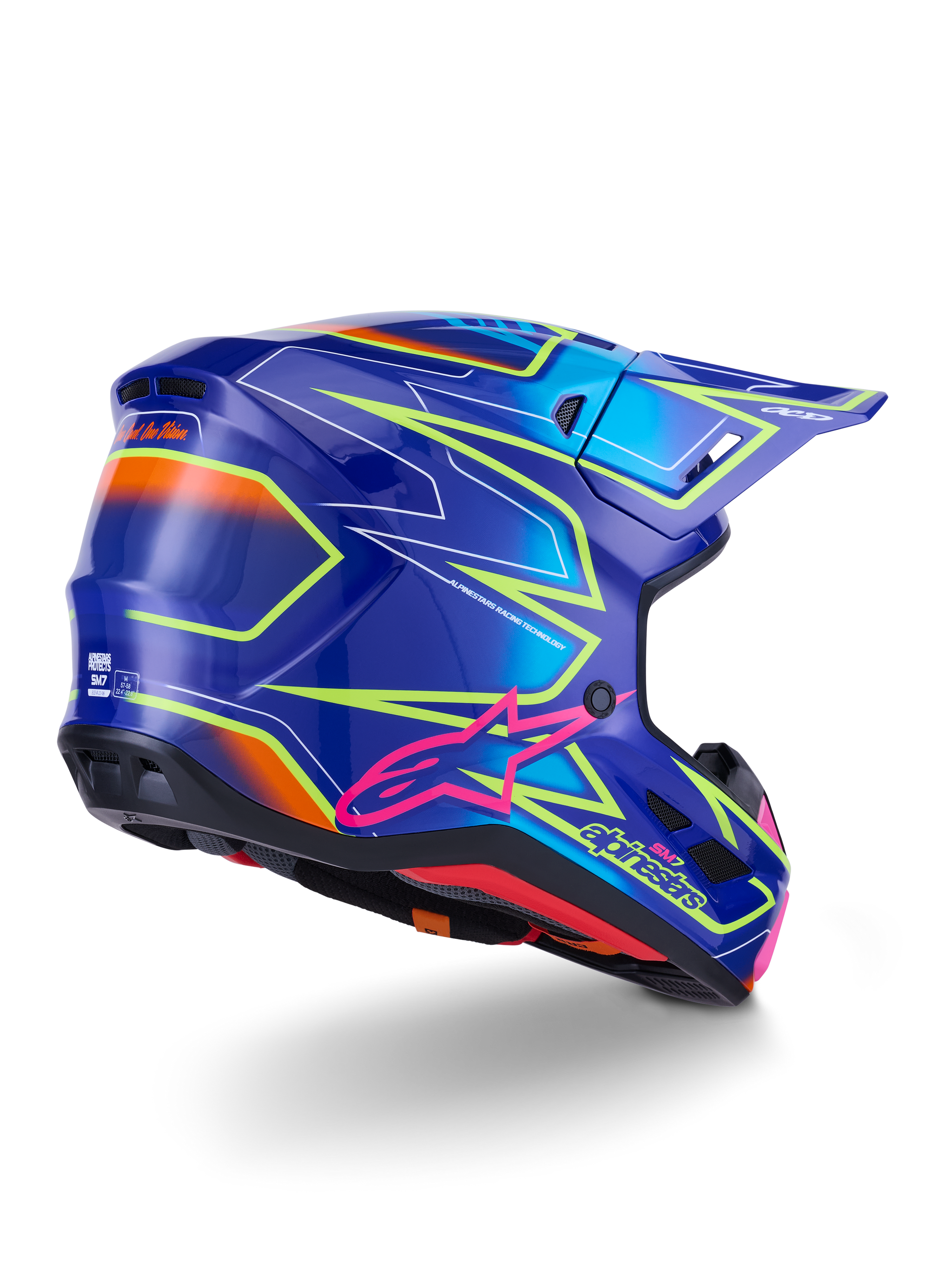 Alpinestars S-M7 Cast-hjälm, motocrosshjälm, blå, rosa och neongul blank finish, vy snett bakifrån som visar det aerodynamiska skalet med markant kantig grafik, rosa Astar-logotyp och integrerade ventilationsöppningar för terrängkörning