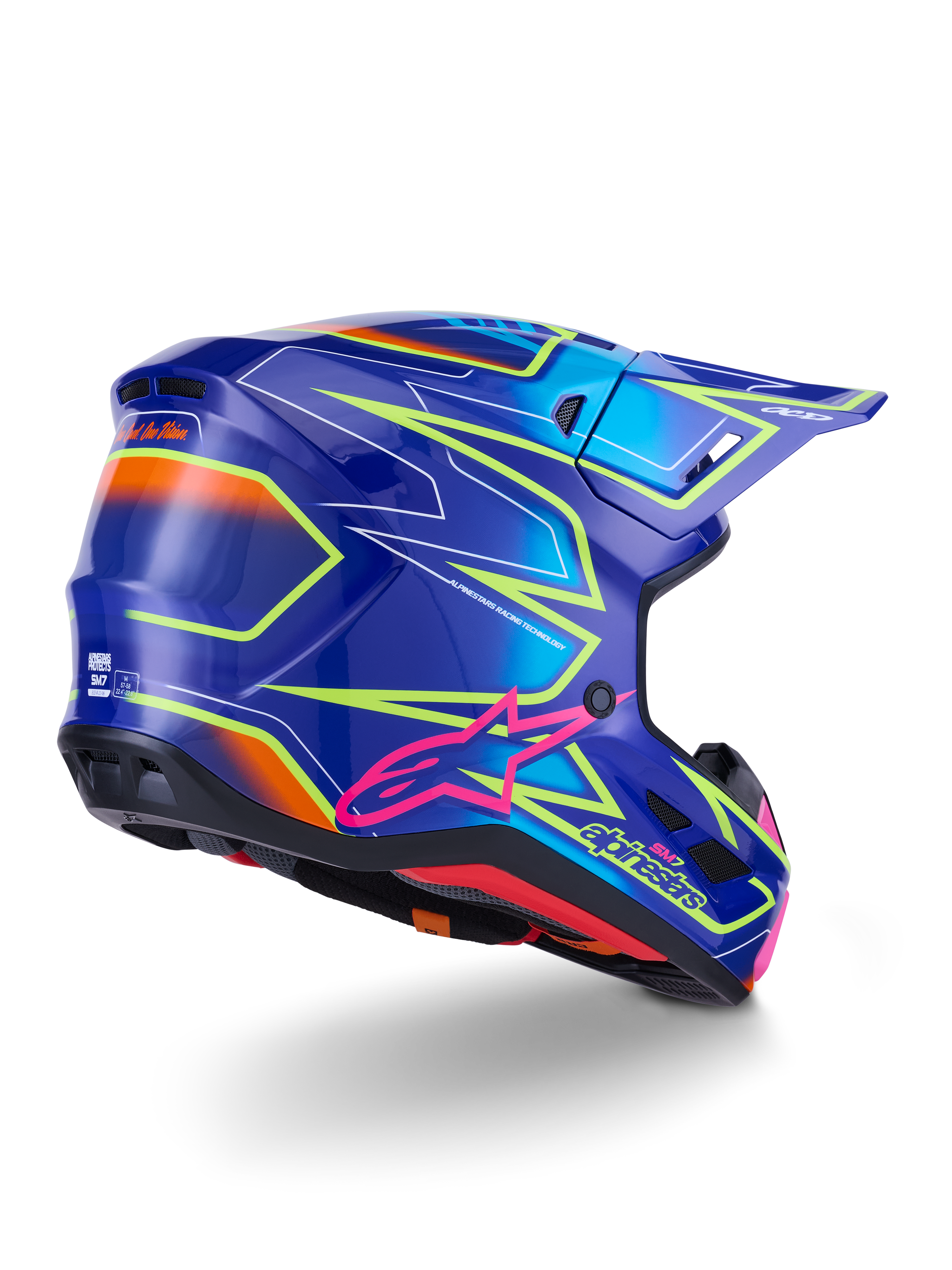 Alpinestars S-M7 Cast-hjälm, motocrosshjälm, blå, rosa och neongul blank finish, vy snett bakifrån som visar det aerodynamiska skalet med markant kantig grafik, rosa Astar-logotyp och integrerade ventilationsöppningar för terrängkörning