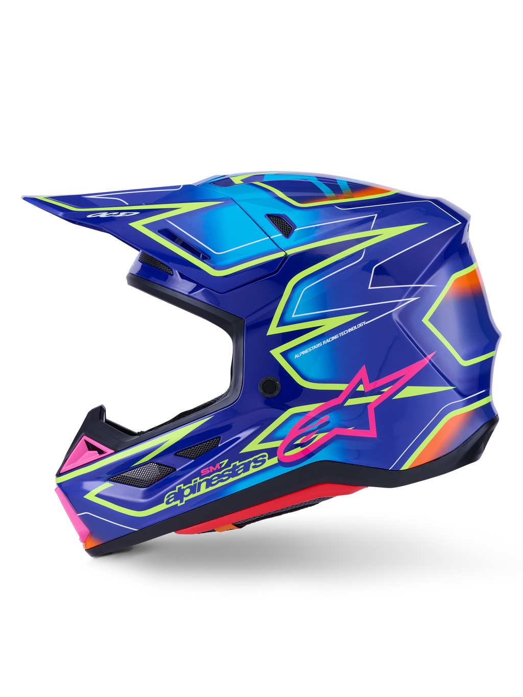 Alpinestars S-M7 Cast hjälm, motocrosshjälm, blå med rosa och neongula glansiga detaljer, profilvy som visar det aerodynamiska kompositskalet, integrerade ventilationsportar, rosa stjärnlogotyp och gul logotyp, konstruerad för skydd vid terrängkörning.