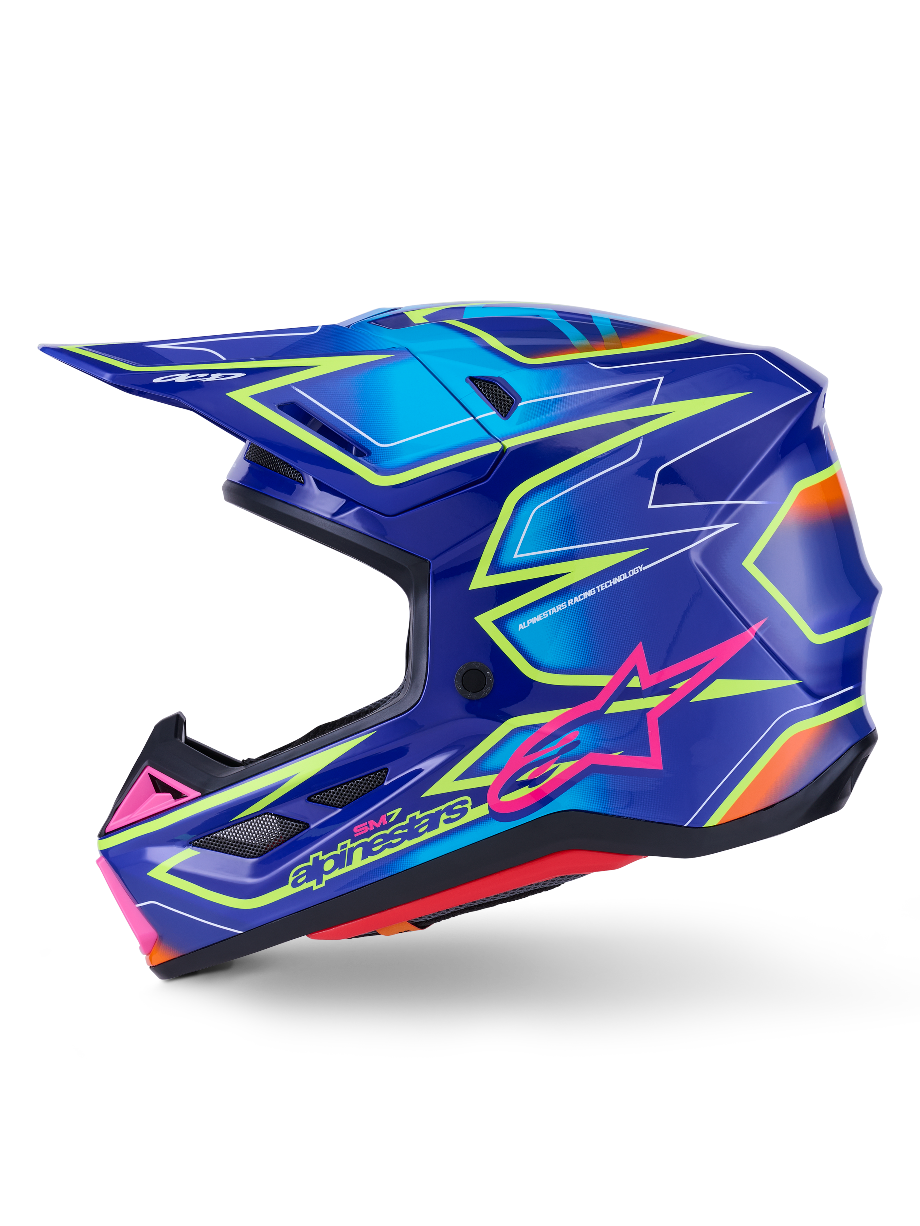 Alpinestars S-M7 Cast hjälm, motocrosshjälm, blå med rosa och neongula glansiga detaljer, profilvy som visar det aerodynamiska kompositskalet, integrerade ventilationsportar, rosa stjärnlogotyp och gul logotyp, konstruerad för skydd vid terrängkörning.