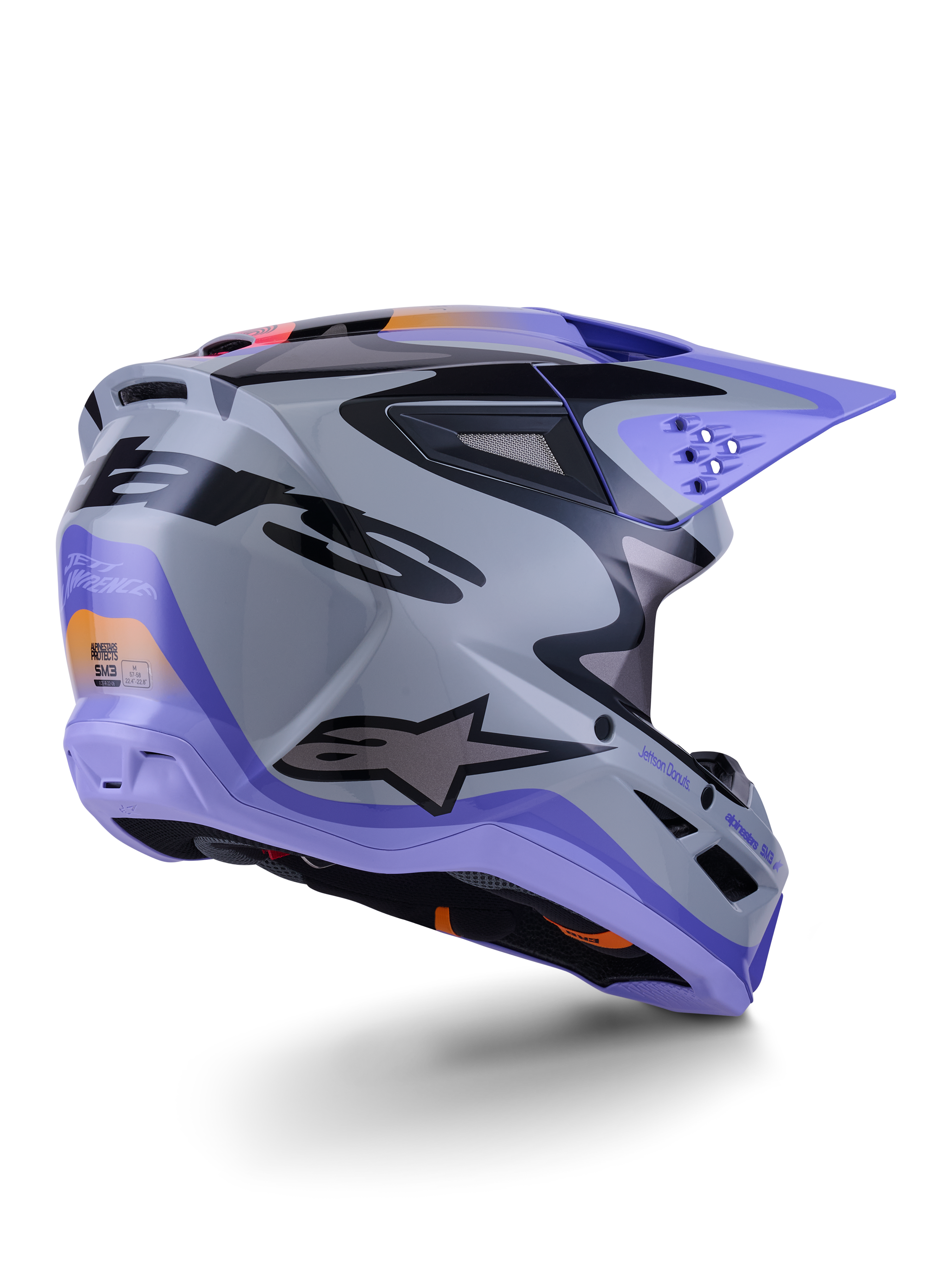 Alpinestars S-M3 Jettson-hjälm ECE 22.06, motocrosshjälm, grå, lila och glansig svart, trekvartsvy bakifrån som visar aerodynamiskt termoinjicerat skal med ventilationsportar och djärv grafisk design