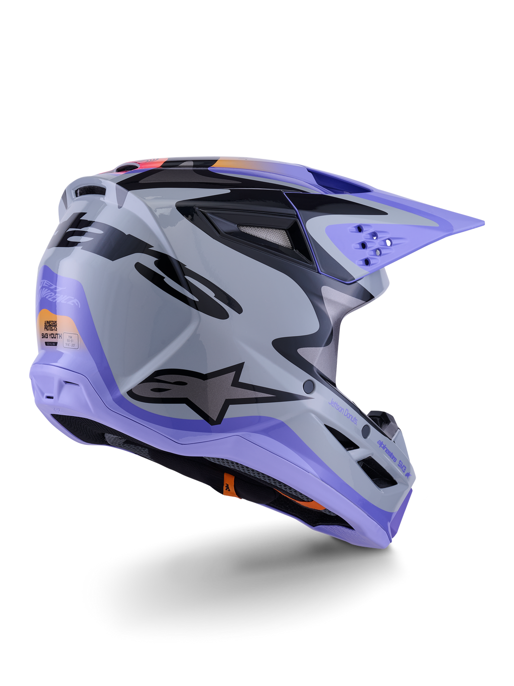 Alpinestars S-M3 Jettson ungdomshjälm, motocrosshjälm, grå, lila och svart glansig, trekvartsvy bakifrån, med lila visir, svart Alpinestars-logotyp och flera ventilationsöppningar, strömlinjeformad design för terrängkörning för ungdomar