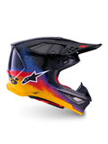 Alpinestars Limited Edition Supertech M10 Black Hole Helmet, Motocross Racing Helmet, Black shell with red, blue, and yellow gradient splatter design, white star logo on side, aerodynamic profile with mesh-covered ventilation ports, red interior padding, and long black visor.