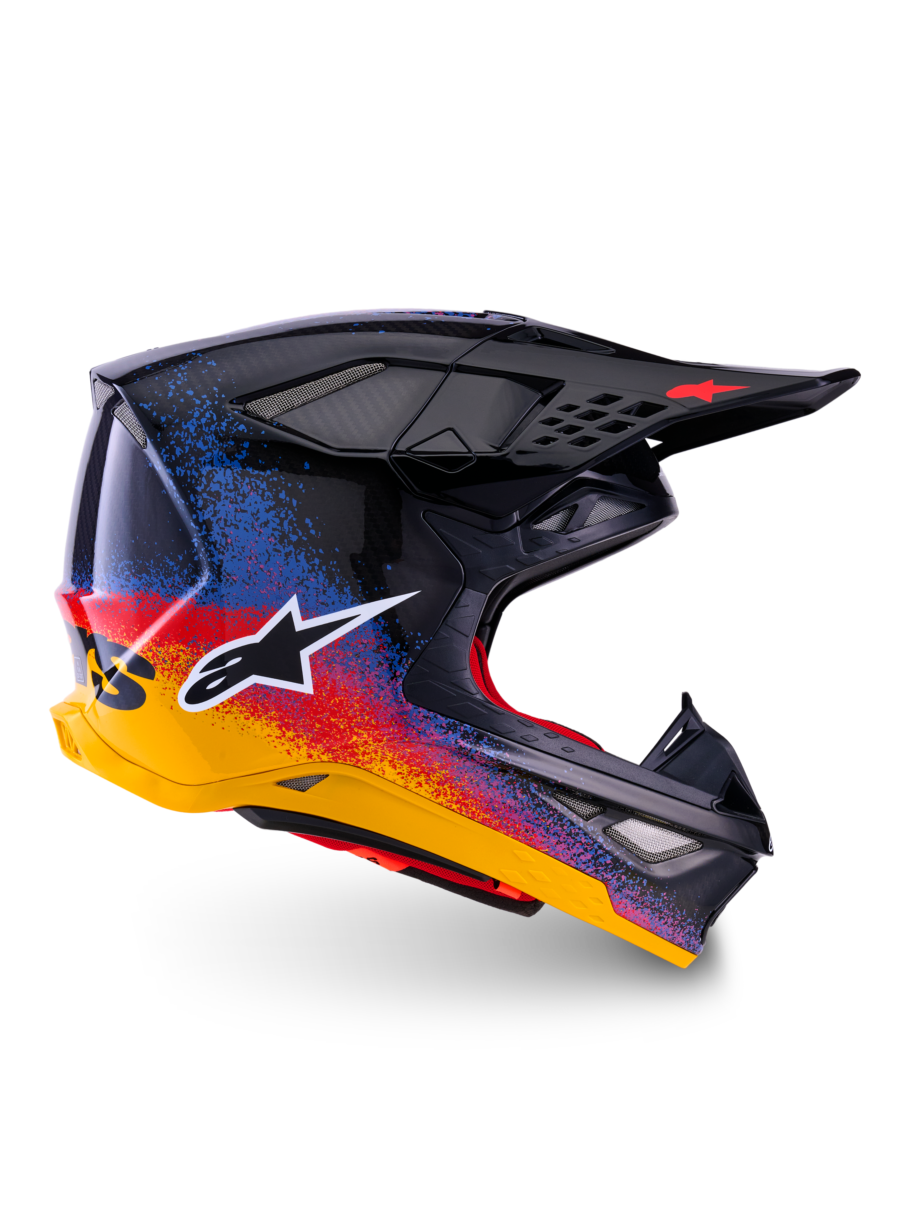 Alpinestars Limited Edition Supertech M10 Black Hole-hjälm, motocrosshjälm, svart skal med röd, blå och gul gradient-stänkdesign, vit stjärnlogotyp på sidan, aerodynamisk profil med nätklädda ventilationsöppningar, röd invändig vaddering och långt svart visir.