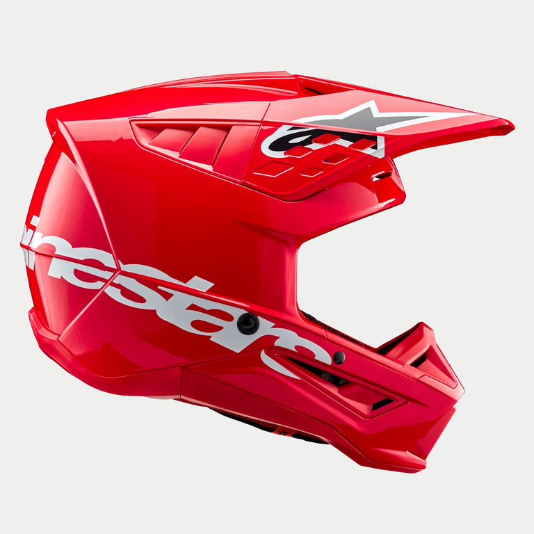 Alpinestars S-M5 Corp Helmet ECE, Motocross Helmet, Bright Red Glossy, side profile view showing a large white Alpinestars logo on the lower shell, aerodynamic ventilated visor with star logo, and high-gloss finish for off-road racing protection