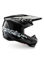 Alpinestars S-M5 Corp motocrosshjälm, mörkgrå glansig finish, ECE 22.06-certifierad med ett lätt termoplastskal och vit logotyp.
