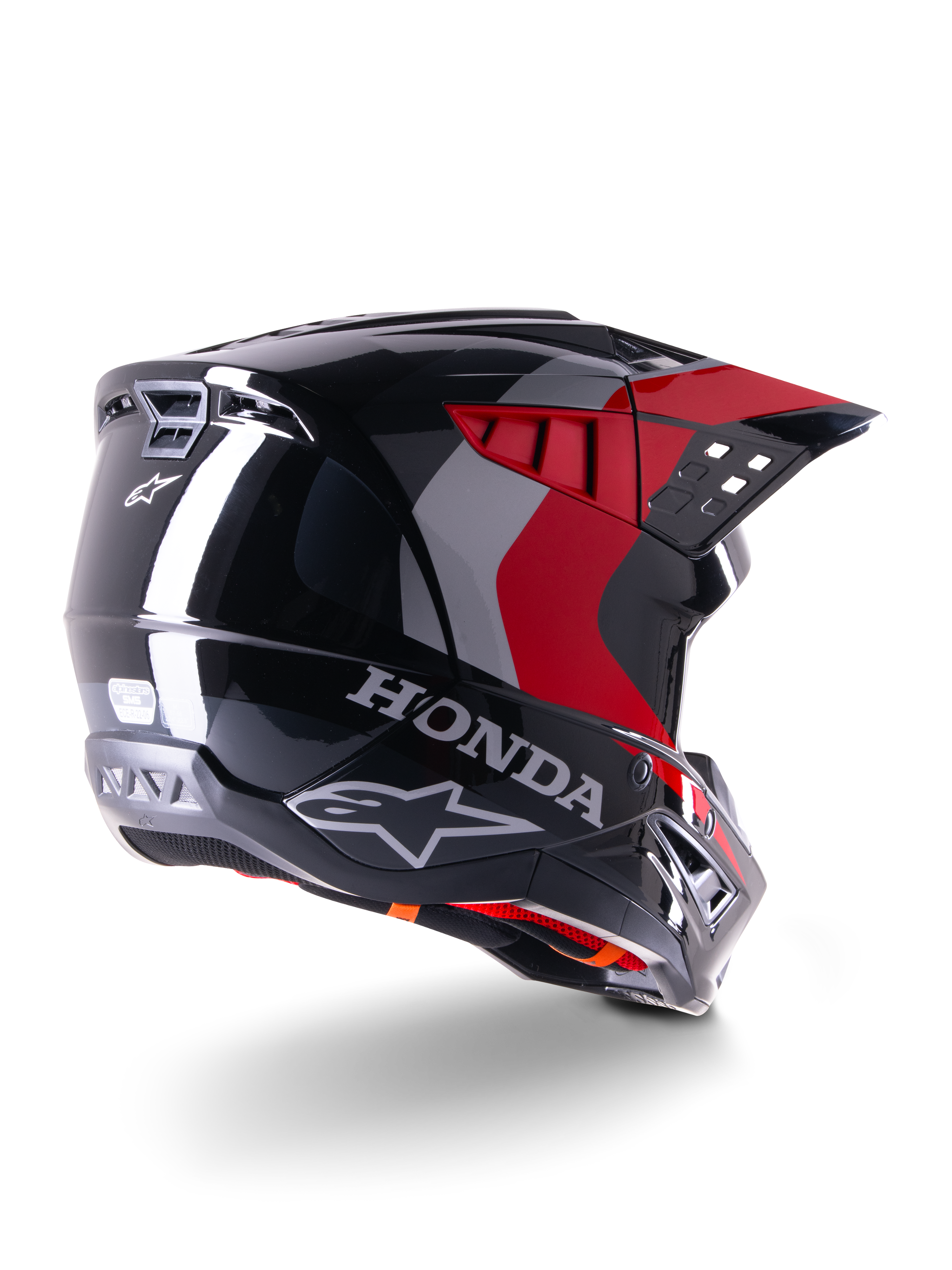 Alpinestars Honda S-M5 ECE-hjälm, motocrosshjälm, blank svart och röd, trekvartsvy bakifrån med Honda-logotyp och Alpinestars-logotyper, blank finish med röda och grå grafiska detaljer, designad för skydd vid terrängkörning
