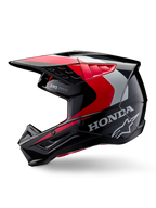 Alpinestars Honda S-M5-hjälm, motocrosshjälm, svart, röd och silver med glansig finish, profilvy med Honda-branding och Alpinestars stjärnlogotyp, strömlinjeformad design med integrerad skärm och ventilationsportar för terrängkörning