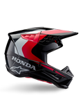 Honda S-M5-hjälm, motocrosshjälm, blank svart och röd med detaljer i vitt och silver, sidovy med logotyper från Honda och Alpinestars, aerodynamisk design med skärm och flera ventilationsöppningar, professionell skyddsutrustning för terrängkörning