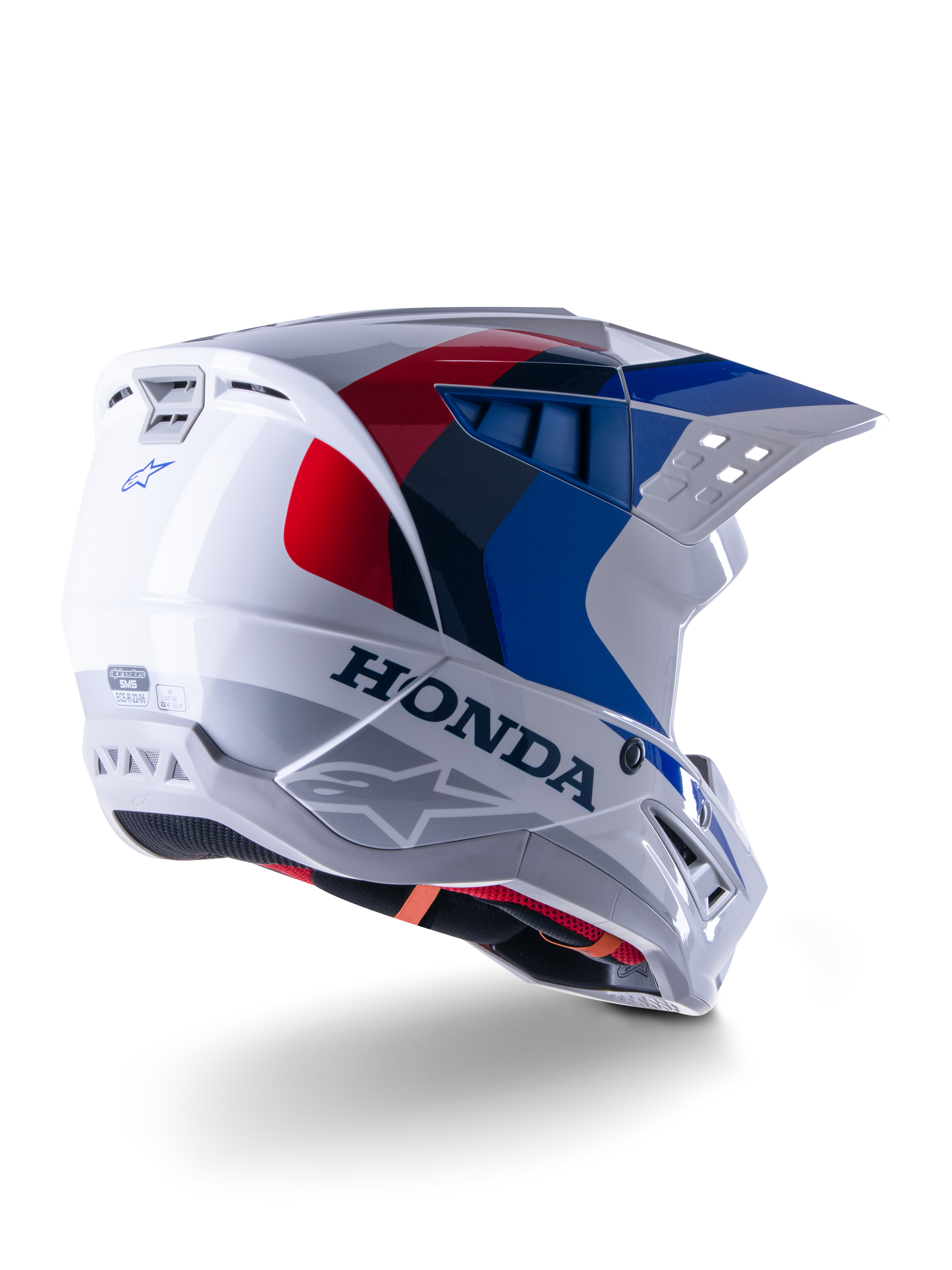 Alpinestars Honda S-M5-hjälm ECE, motocrosshjälm, vit, blå och röd i glansig finish, med tydlig Honda-branding och Alpinestars-logotyper, aerodynamiskt skal med integrerade ventilationsöppningar och justerbart visir, skyddsutrustning för terrängkörning
